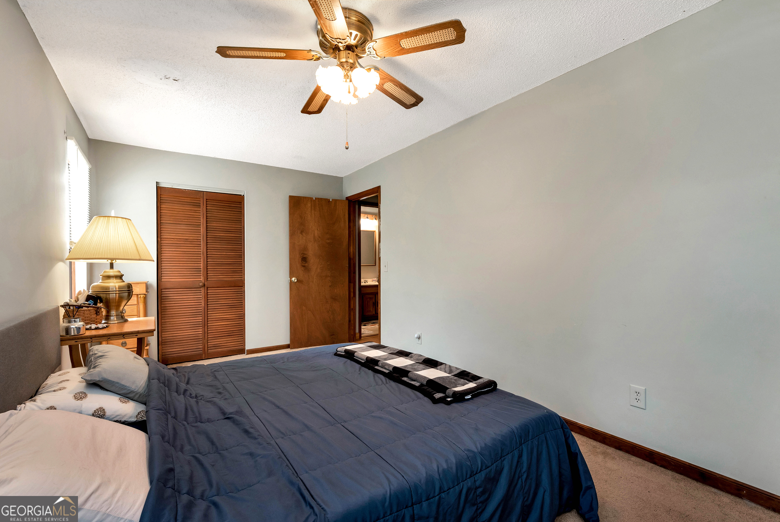 373 Jennys Cove Road Cleveland, GA 30528 - Photo 28 of 44 a bedroom with a bed and a chandelier