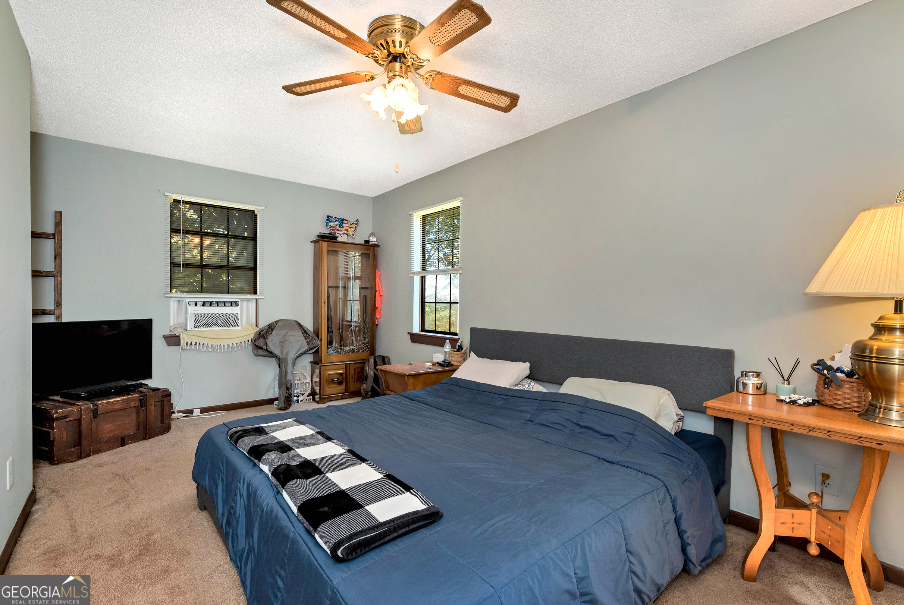 373 Jennys Cove Road Cleveland, GA 30528 - Photo 29 of 44 a bedroom with a bed window and a flat screen tv