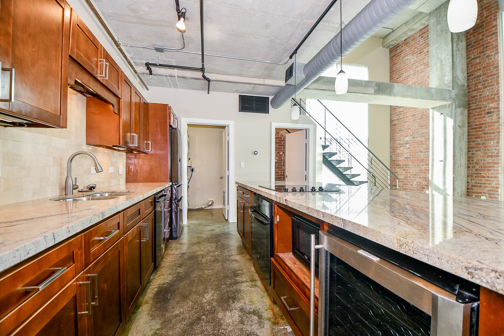 2000 Bagby Street, Unit 5441 Houston, TX 77002 - Photo 14 of 34 a kitchen with granite countertop a sink a stove and wooden cabinets