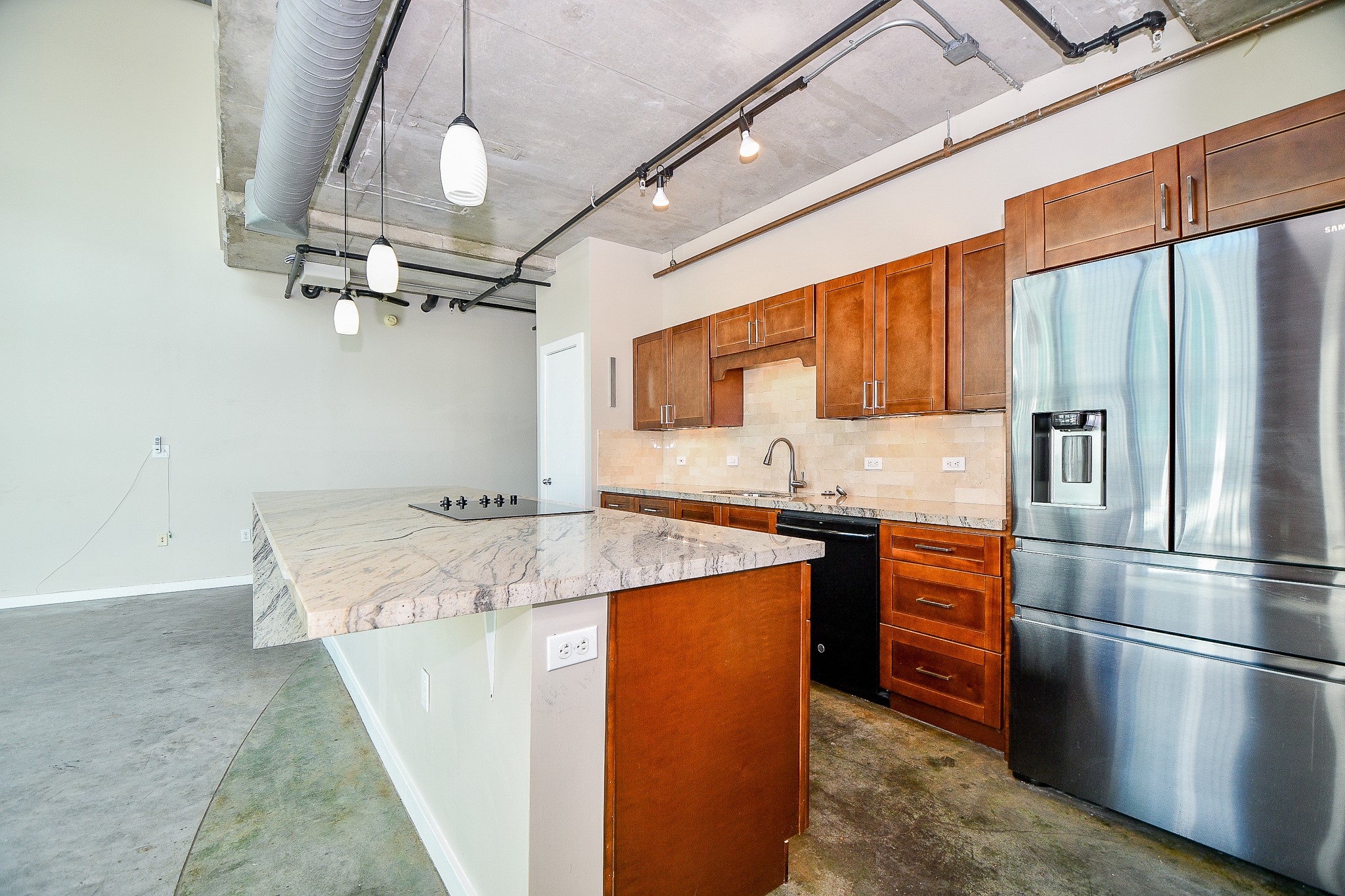 2000 Bagby Street, Unit 5441 Houston, TX 77002 - Photo 15 of 34 a kitchen with kitchen island a counter top space appliances and cabinets