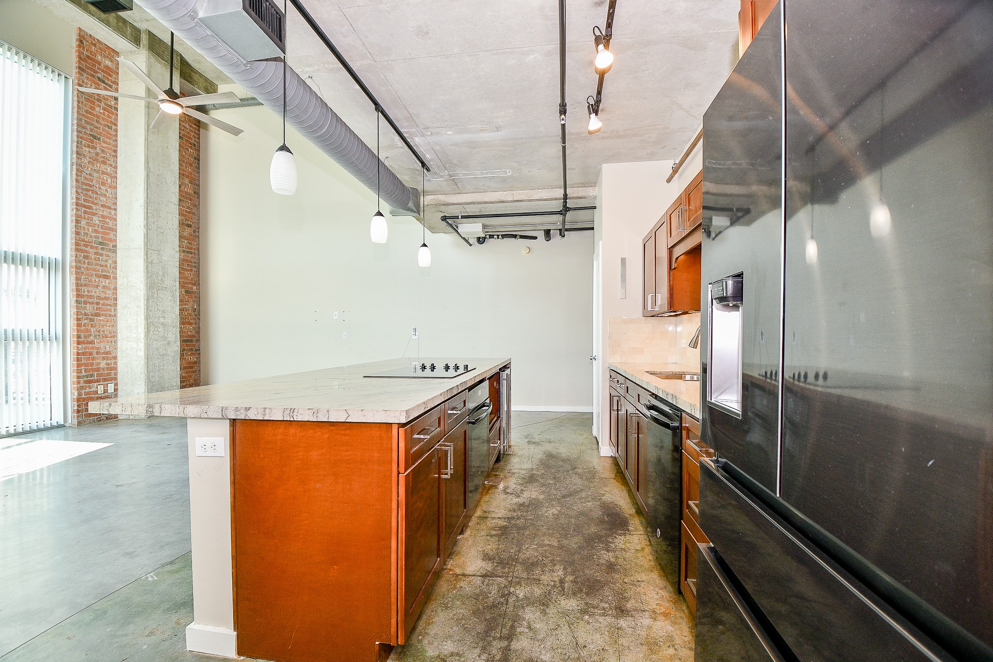 2000 Bagby Street, Unit 5441 Houston, TX 77002 - Photo 17 of 34 a kitchen with granite countertop a sink a counter top space stainless steel appliances and a window