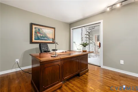 a room with a table chairs and wooden floor