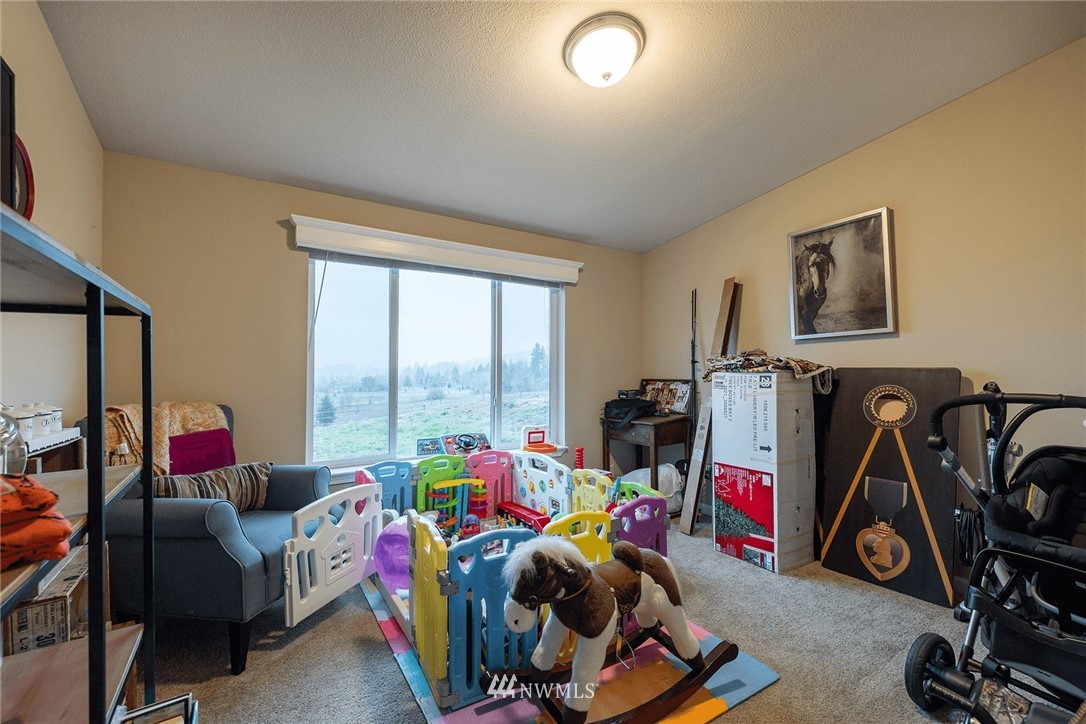 206 Senn Road Chehalis, WA 98532 - Photo 13 of 27 a living room with furniture a gym equipment and a large window