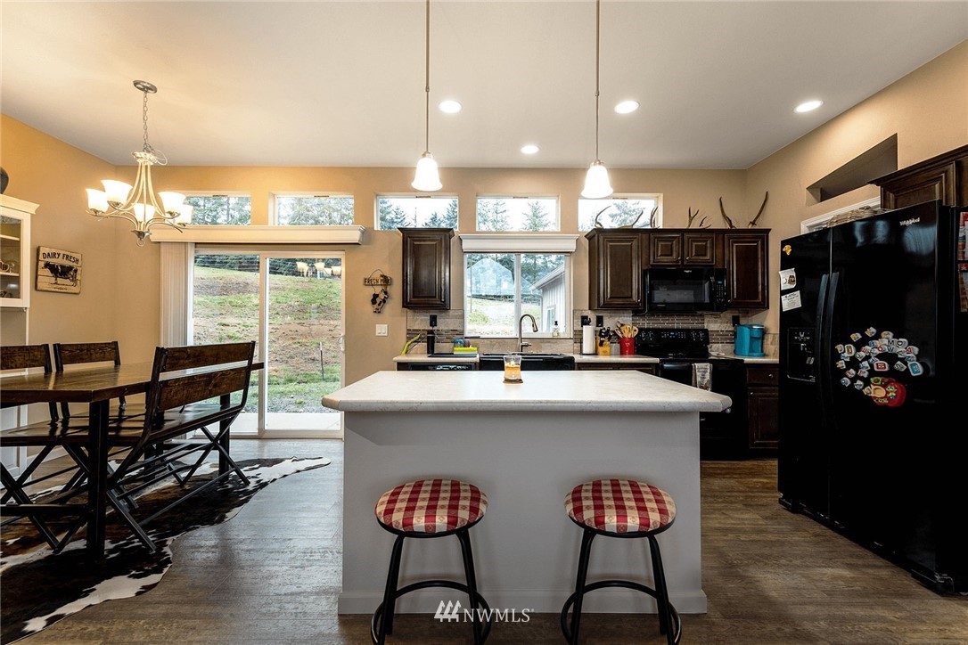 206 Senn Road Chehalis, WA 98532 - Photo 7 of 27 a kitchen with kitchen island a dining table and chairs