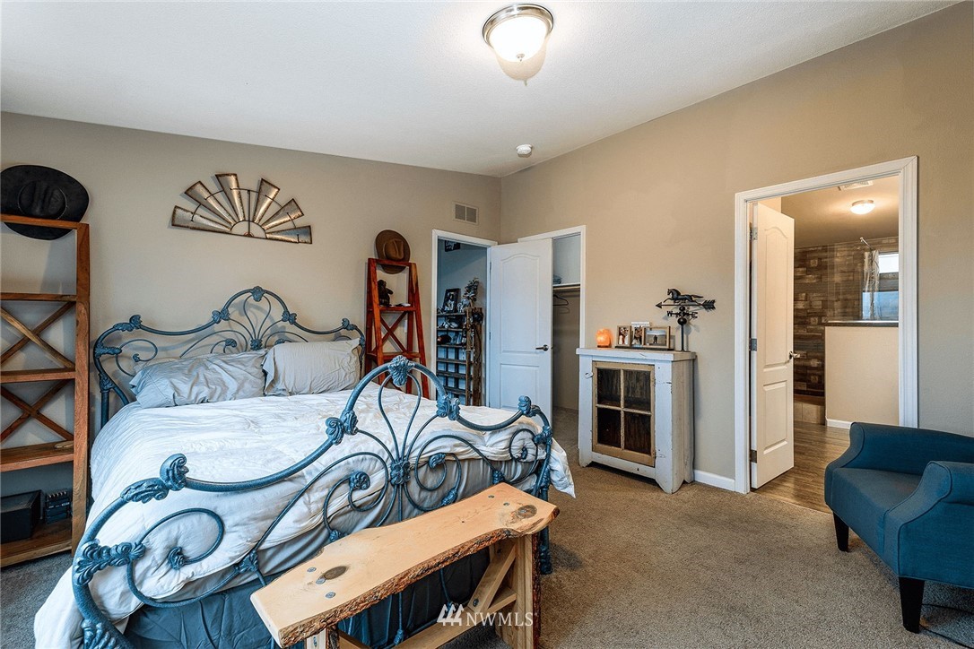 206 Senn Road Chehalis, WA 98532 - Photo 10 of 27 a bedroom with furniture and a chandelier