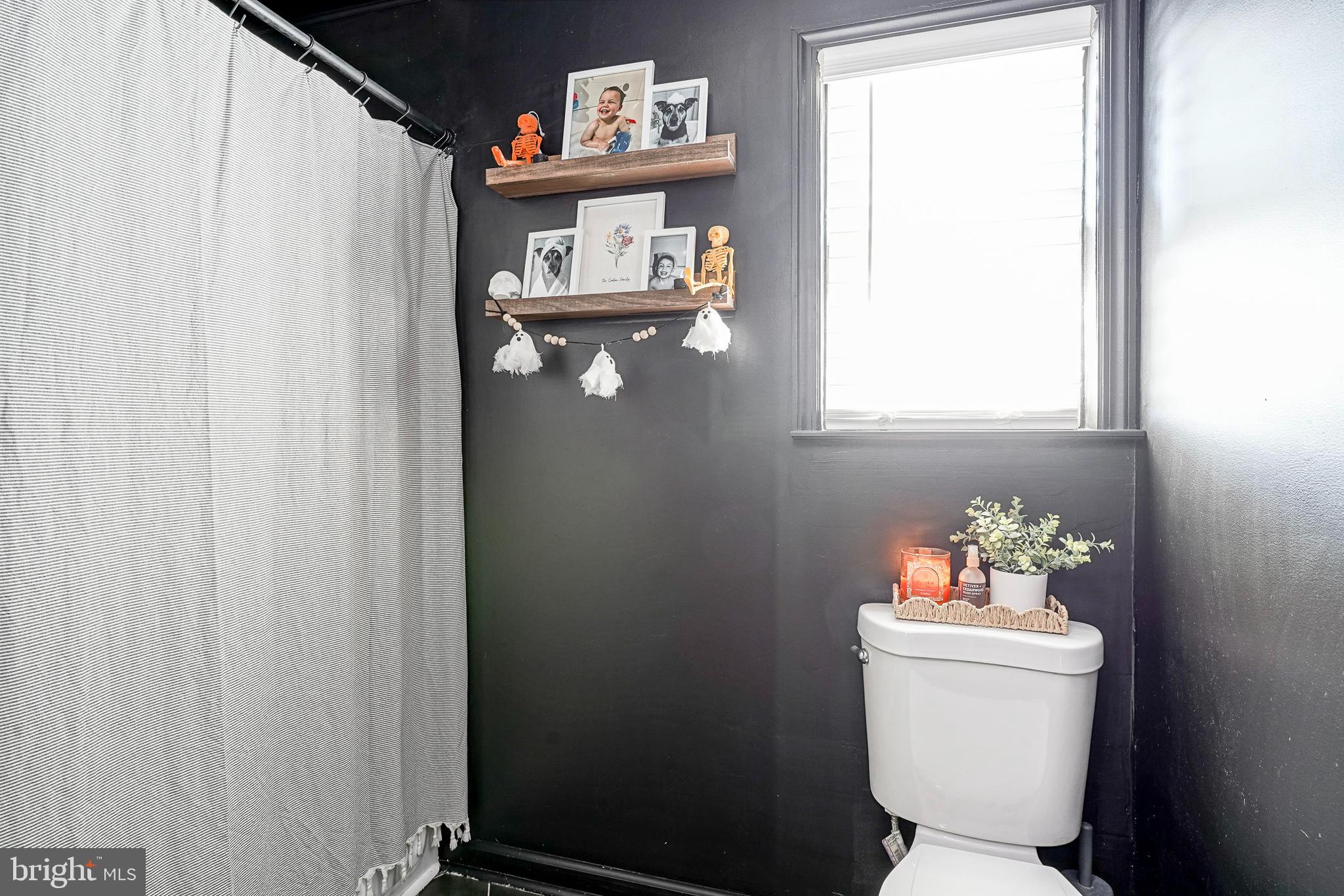 806 West Evesham Road Glendora, NJ 08029 - Photo 11 of 26 a bathroom with a toilet a sink and a window