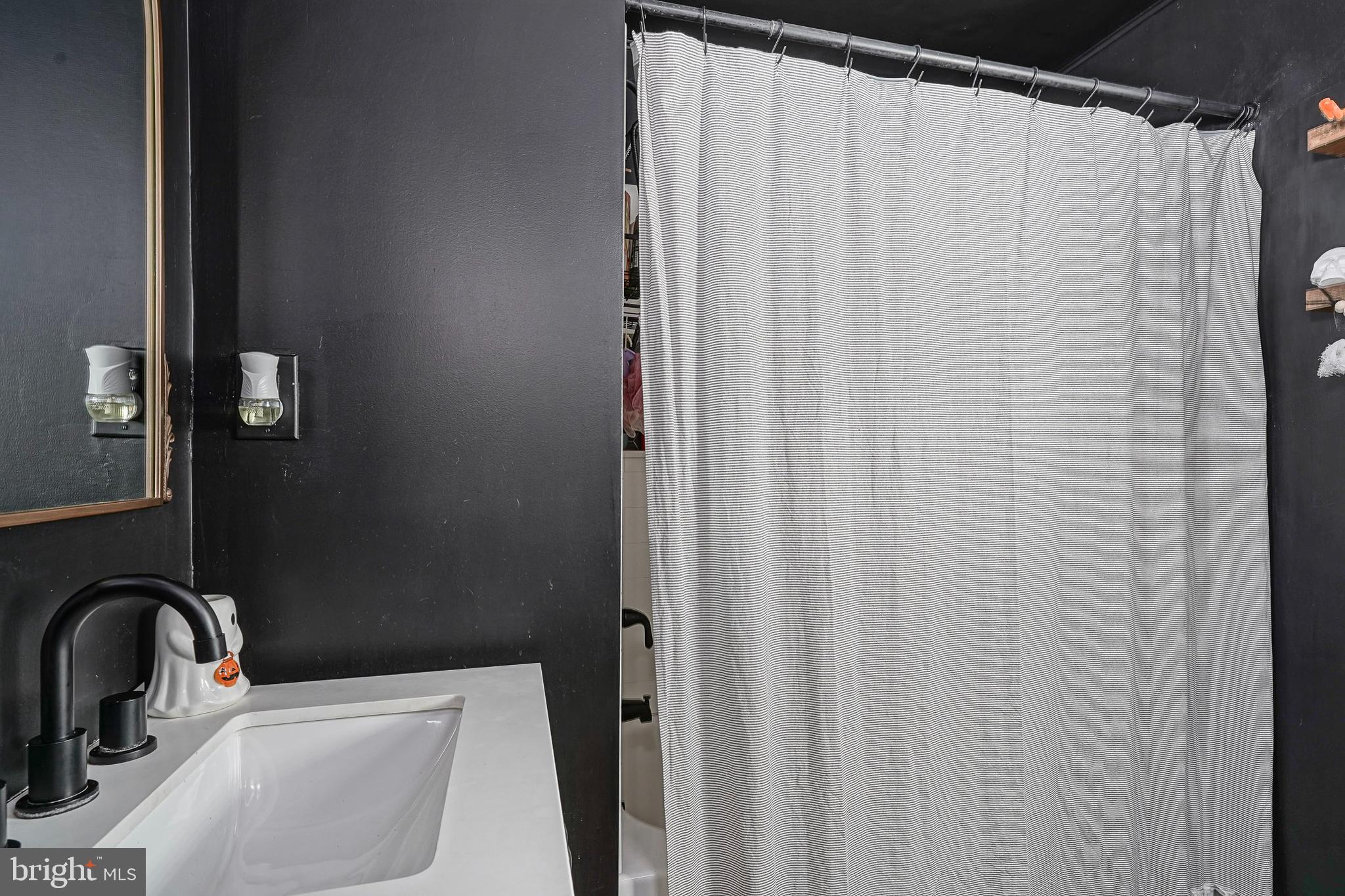 806 West Evesham Road Glendora, NJ 08029 - Photo 13 of 26 a bathroom with a sink a mirror and shower curtain