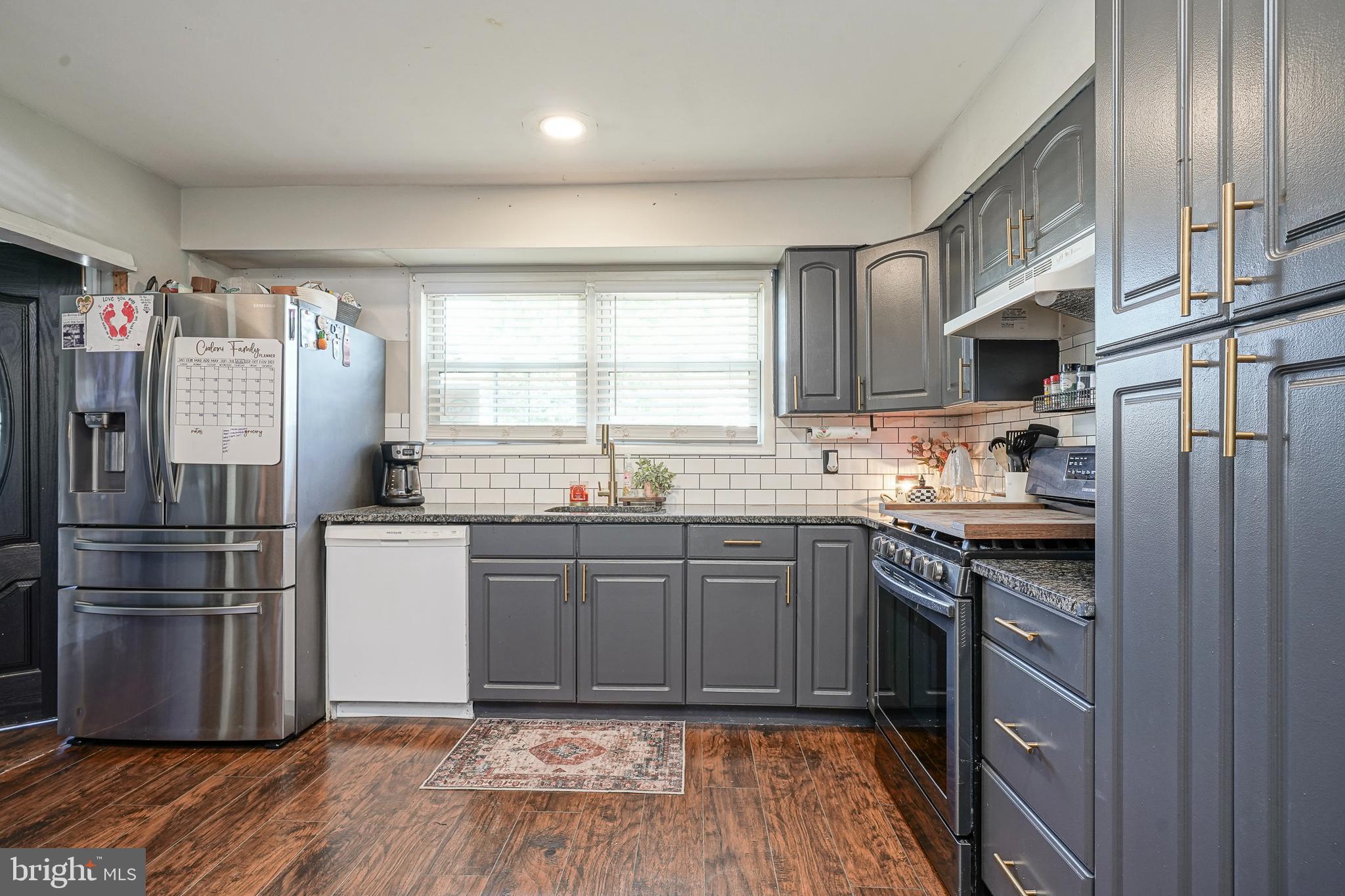 806 West Evesham Road Glendora, NJ 08029 - Photo 5 of 26 a kitchen with granite countertop stainless steel appliances a sink cabinets and a window