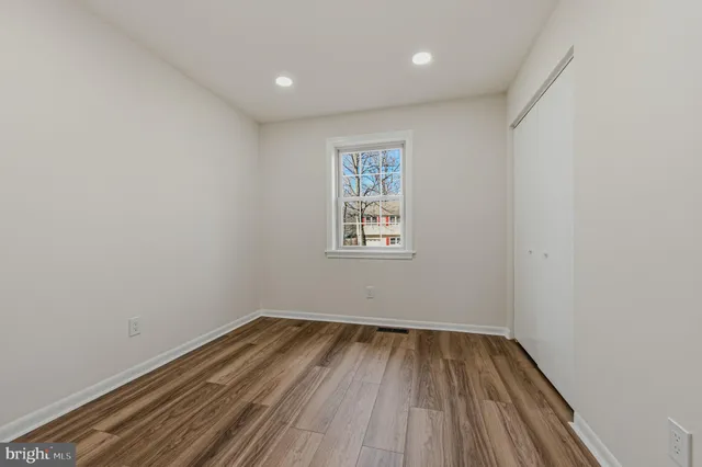 a view of room with wooden floor and window