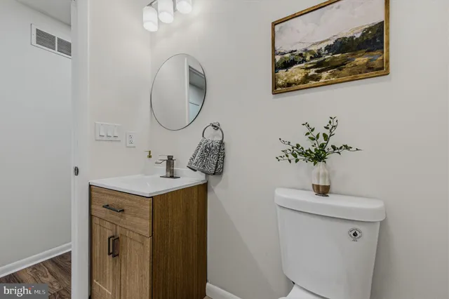 a bathroom with a sink a mirror and a toilet