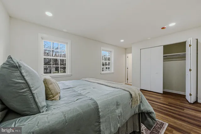 a spacious bedroom with a bed and a window