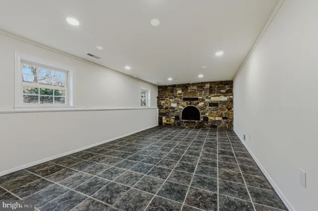 a living room with a black white checkered floor with a rug