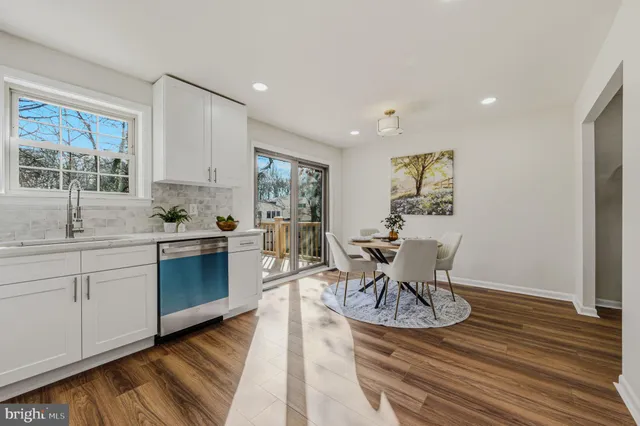 a living room with furniture a wooden floor and a window