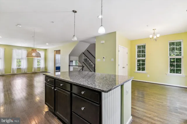 a kitchen with a counter space and wooden floor