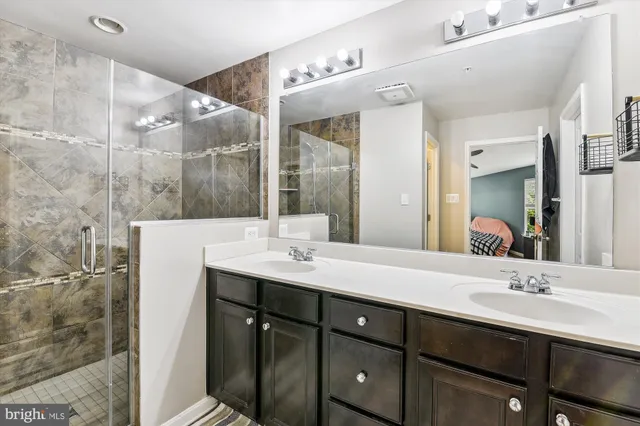 a bathroom with a double vanity sink and mirror