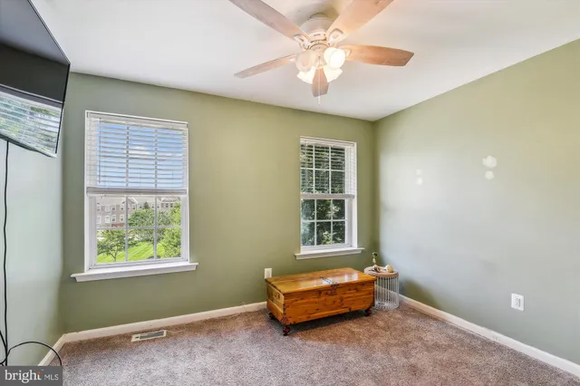 a room with a window and ceiling fan