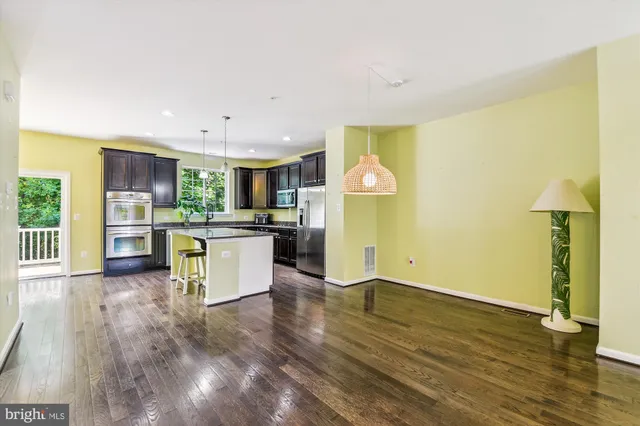 a view of kitchen with furniture and wooden floor