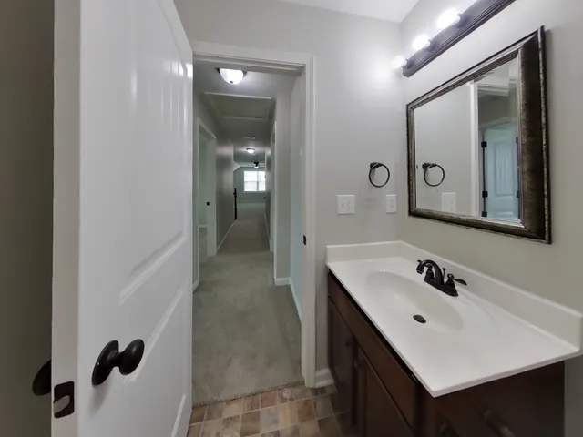 a bathroom with a sink vanity and mirror