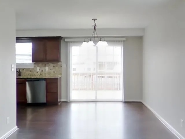 a kitchen with stainless steel appliances granite countertop a stove a sink and a large window