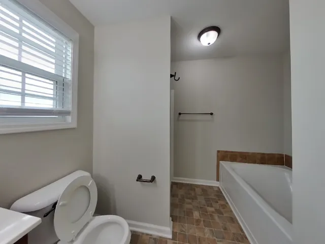 a bathroom with a toilet and a bathtub
