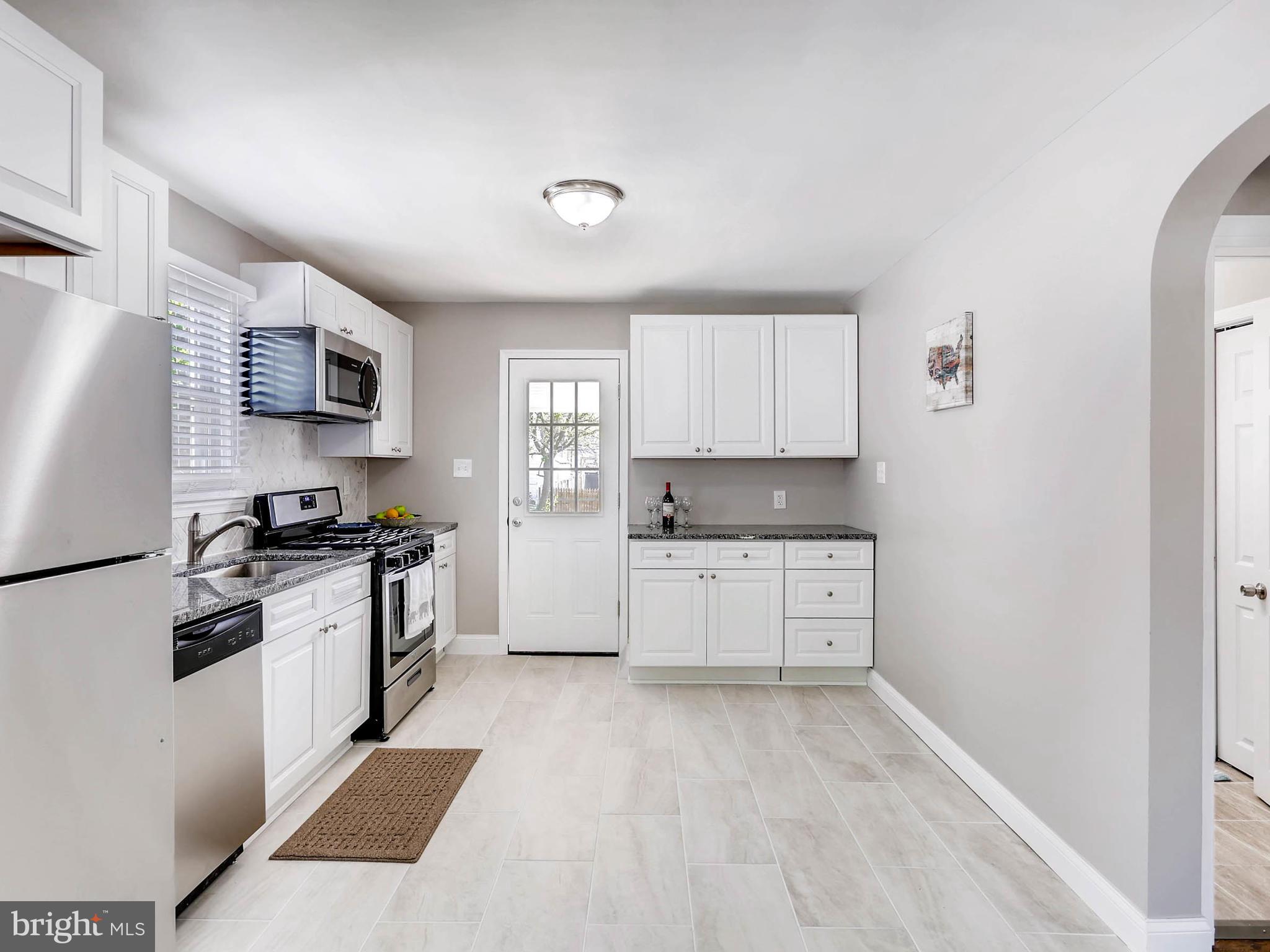 7 Forest Road Middle River, MD 21220 - Photo 6 of 27 a kitchen with granite countertop a stove top oven sink and cabinets