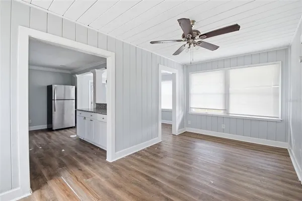 a view of an empty room with wooden floor
