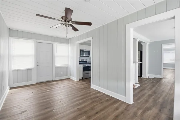 a view of an empty room with wooden floor