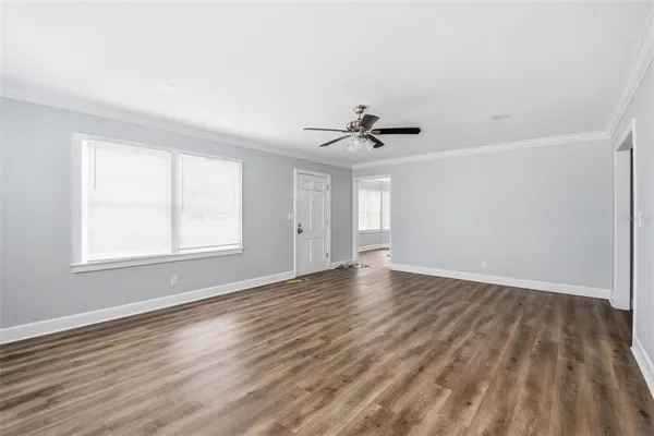 a view of an empty room with wooden floor