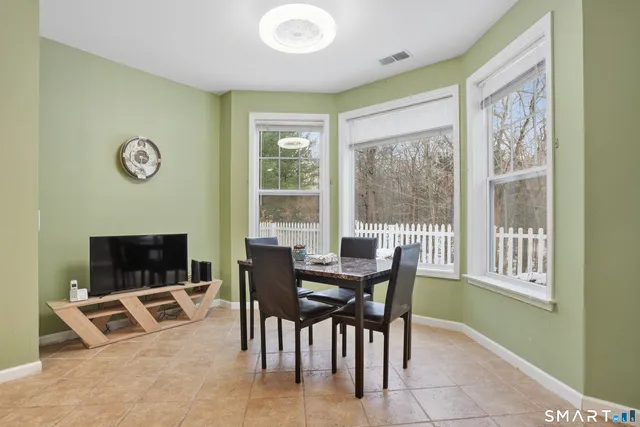 a view of a dining room with furniture and a window