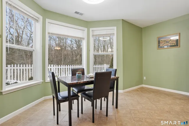 a dining room with furniture and a window