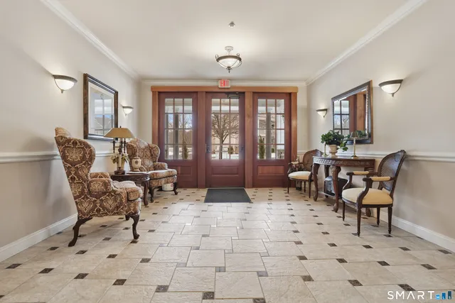 a living room with furniture and a floor to ceiling window
