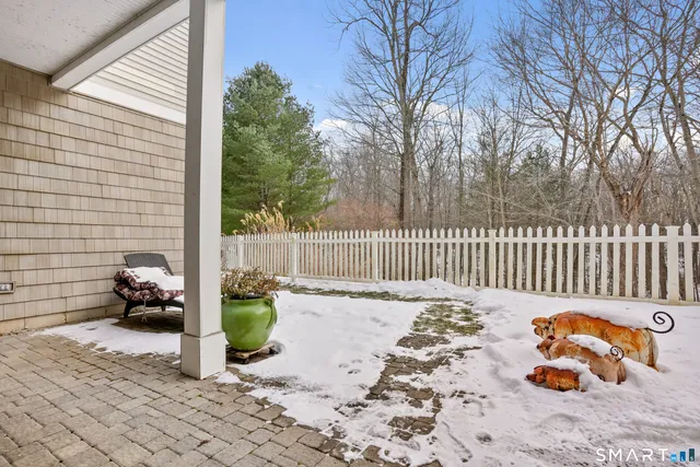a backyard of a house with table and chairs