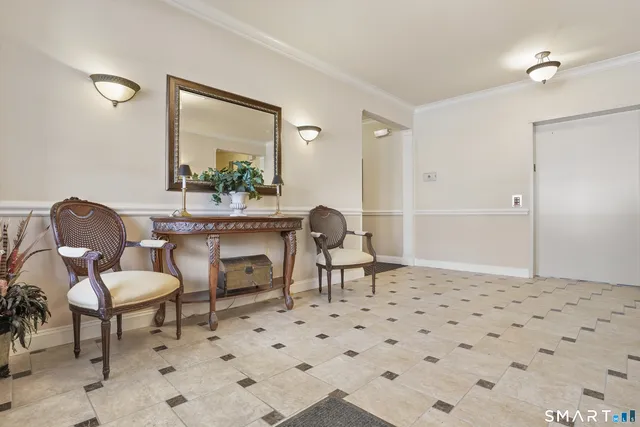 a living room with a couch and a chandelier