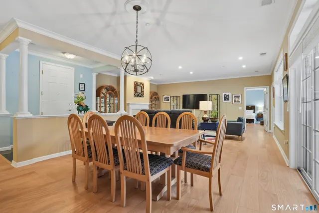 a view of a dining room with furniture wooden floor and chandelier