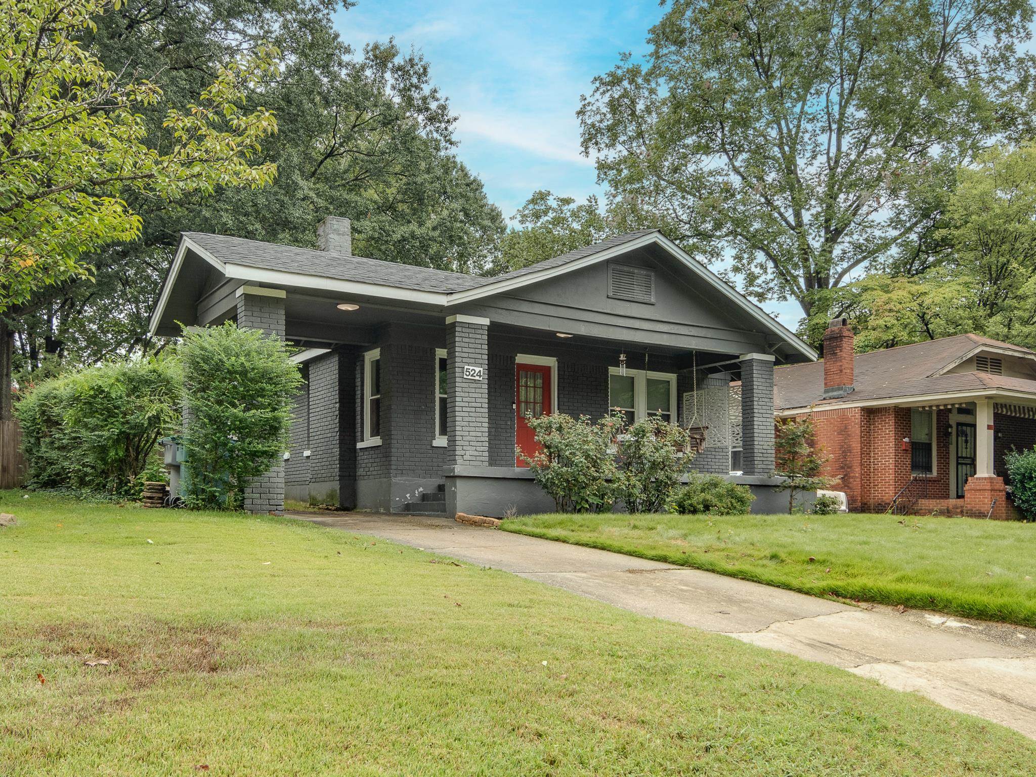 View of front of property featuring covered porch and a front yard