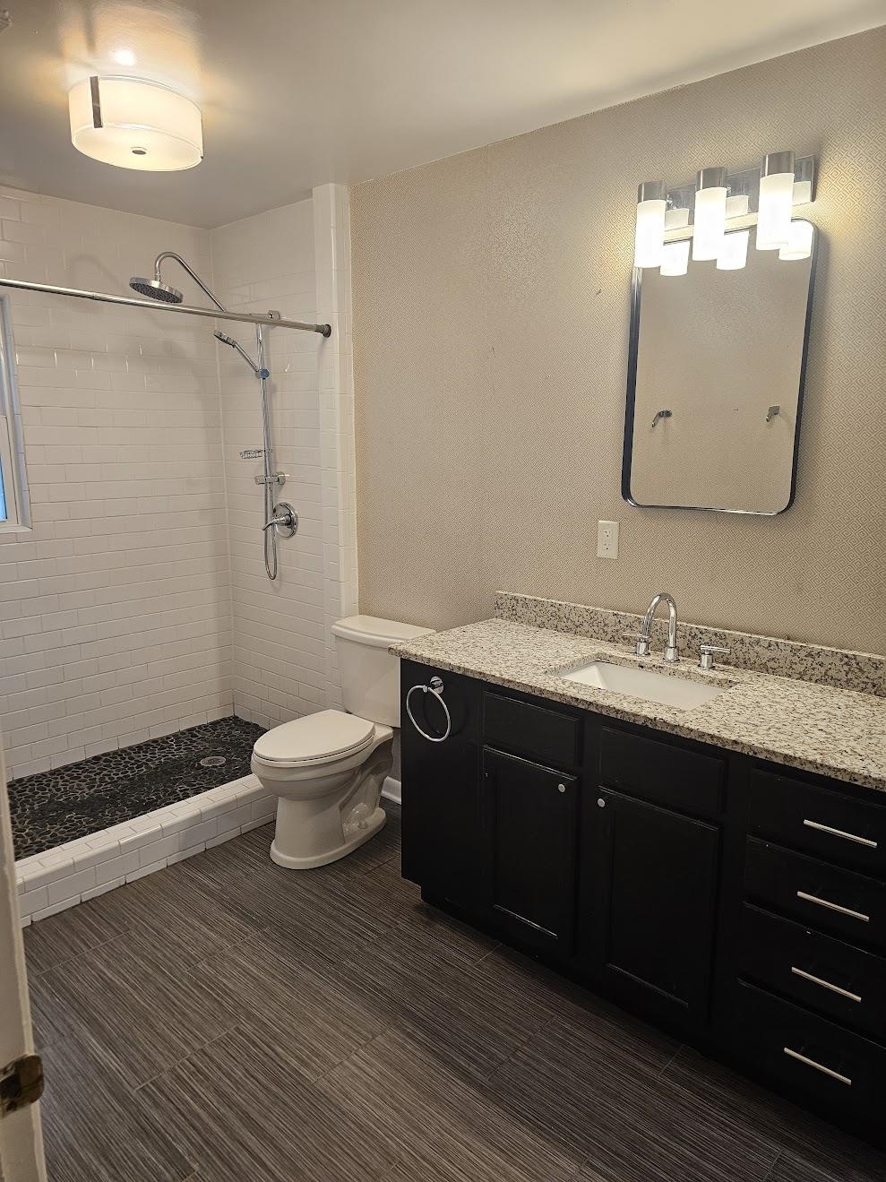 524 Alexander Street Memphis, TN 38111 - Photo 24 of 34 Bathroom featuring tiled shower, tile patterned flooring, toilet, and vanity