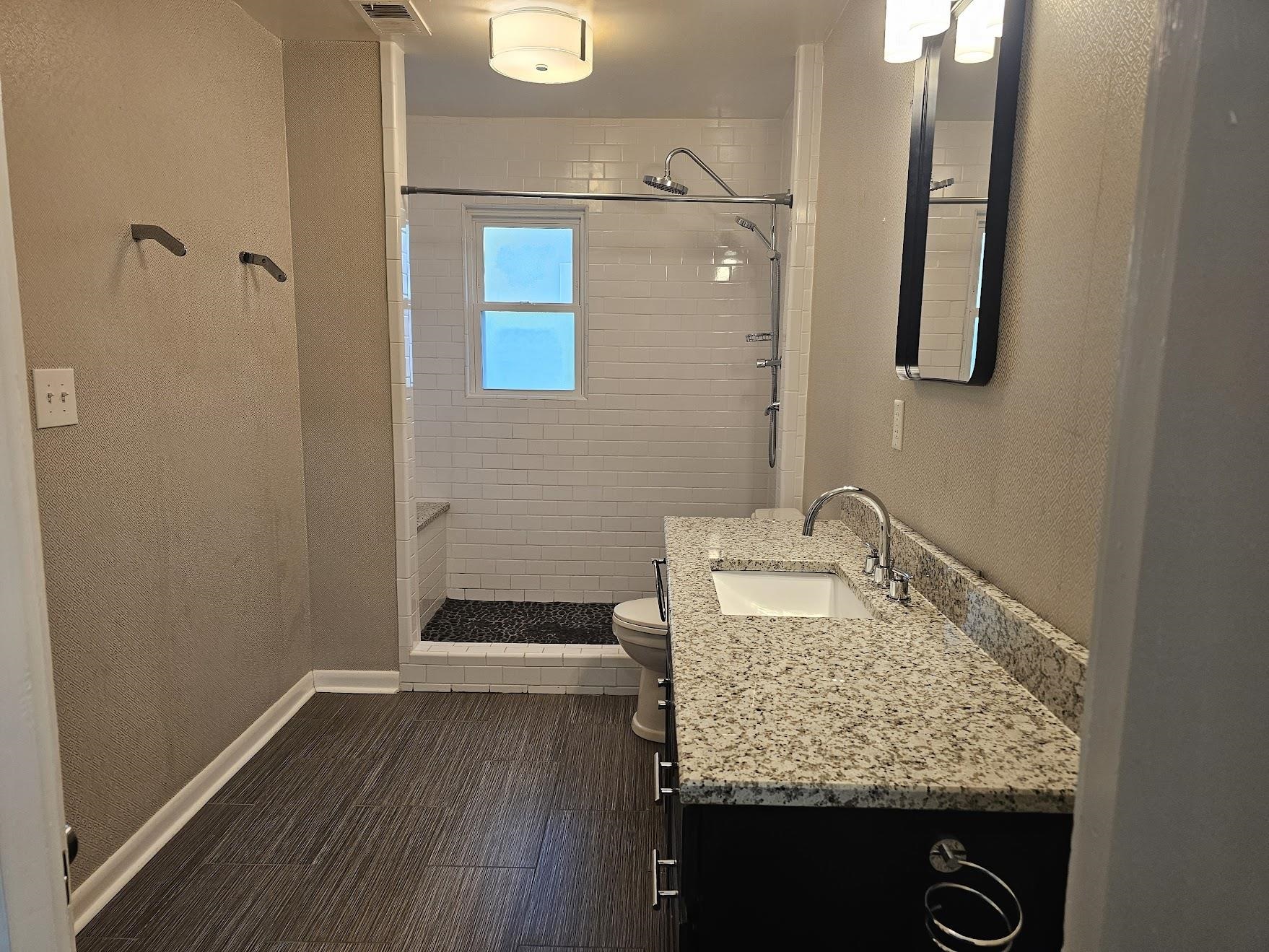 524 Alexander Street Memphis, TN 38111 - Photo 25 of 34 Bathroom featuring toilet, a tile shower, and vanity