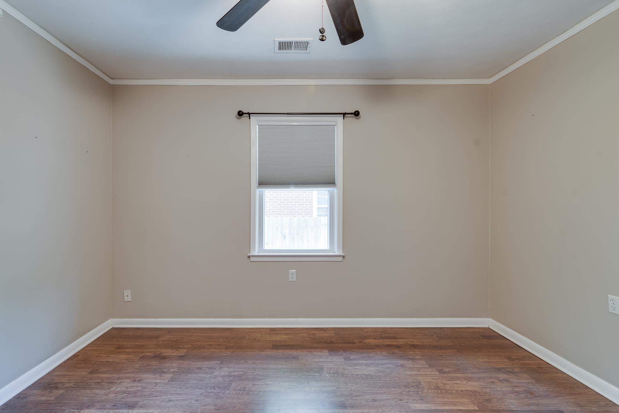 524 Alexander Street Memphis, TN 38111 - Photo 28 of 34 Unfurnished room featuring ceiling fan, wood-type flooring, and ornamental molding