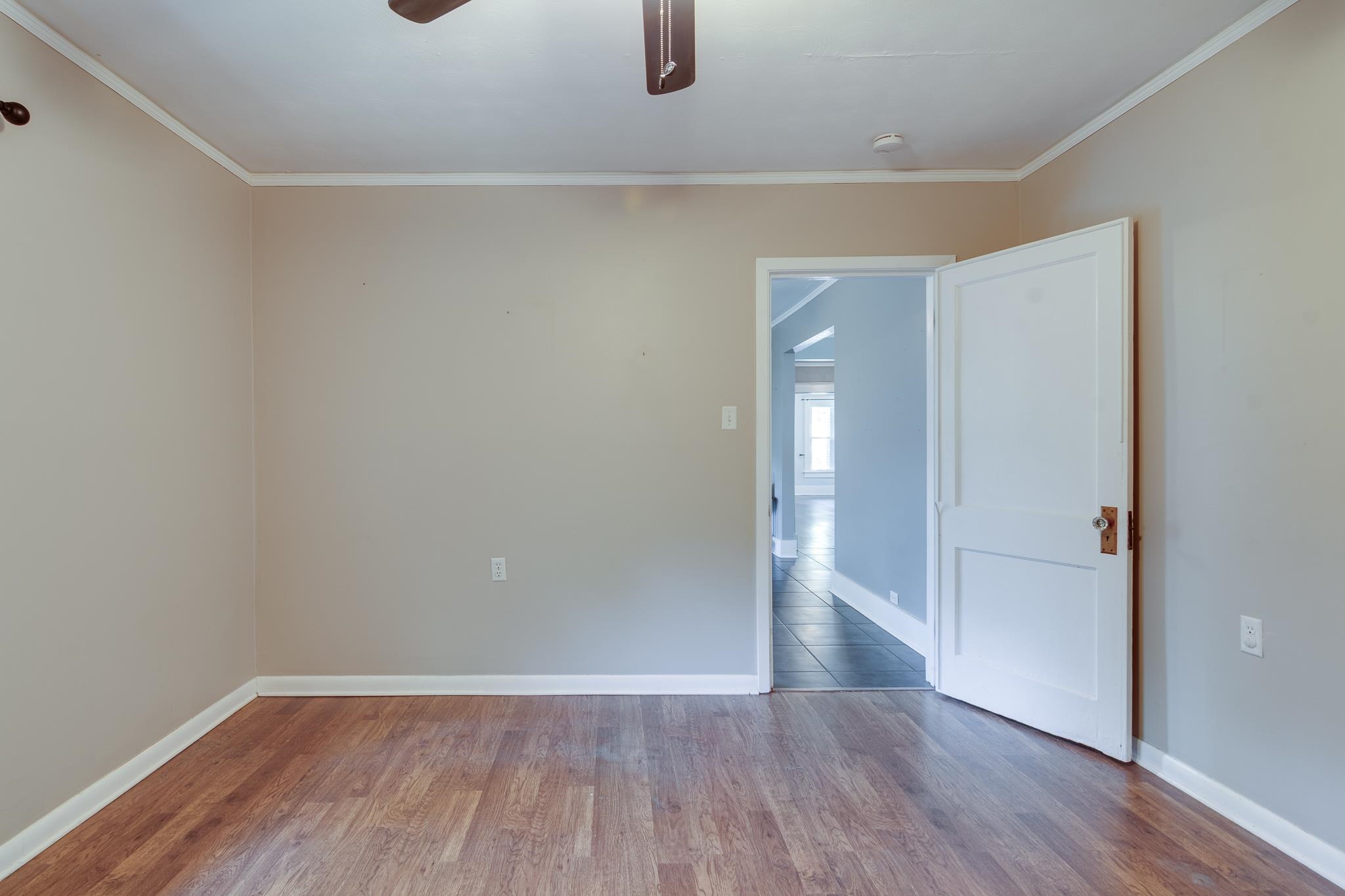 524 Alexander Street Memphis, TN 38111 - Photo 29 of 34 Empty room with ceiling fan, crown molding, and hardwood / wood-style floors