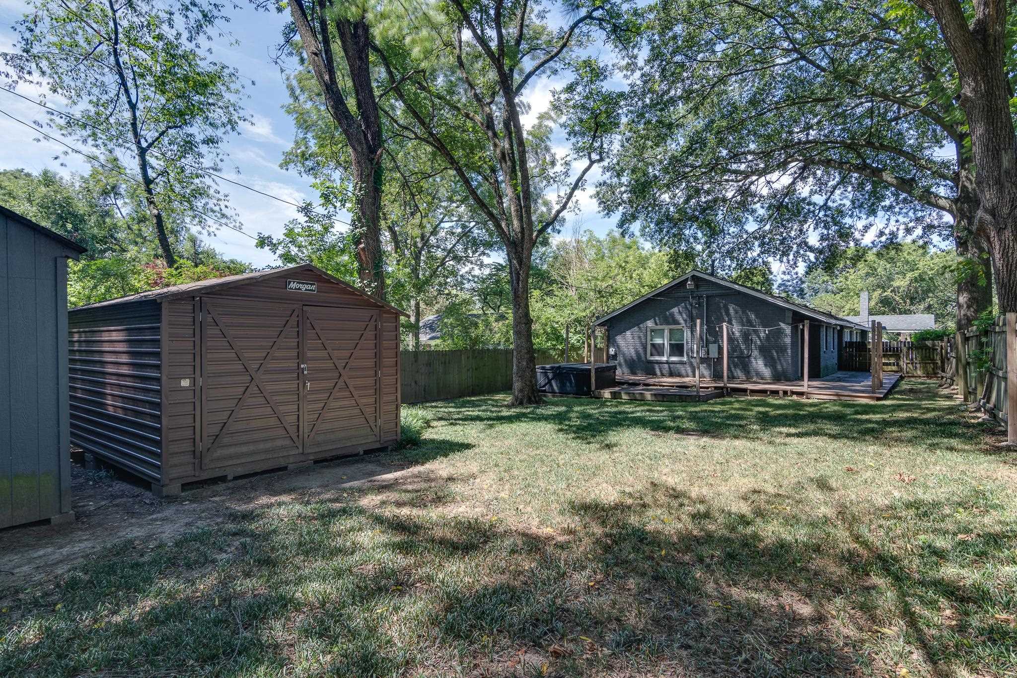 524 Alexander Street Memphis, TN 38111 - Photo 33 of 34 View of yard featuring a storage shed and a sunroom