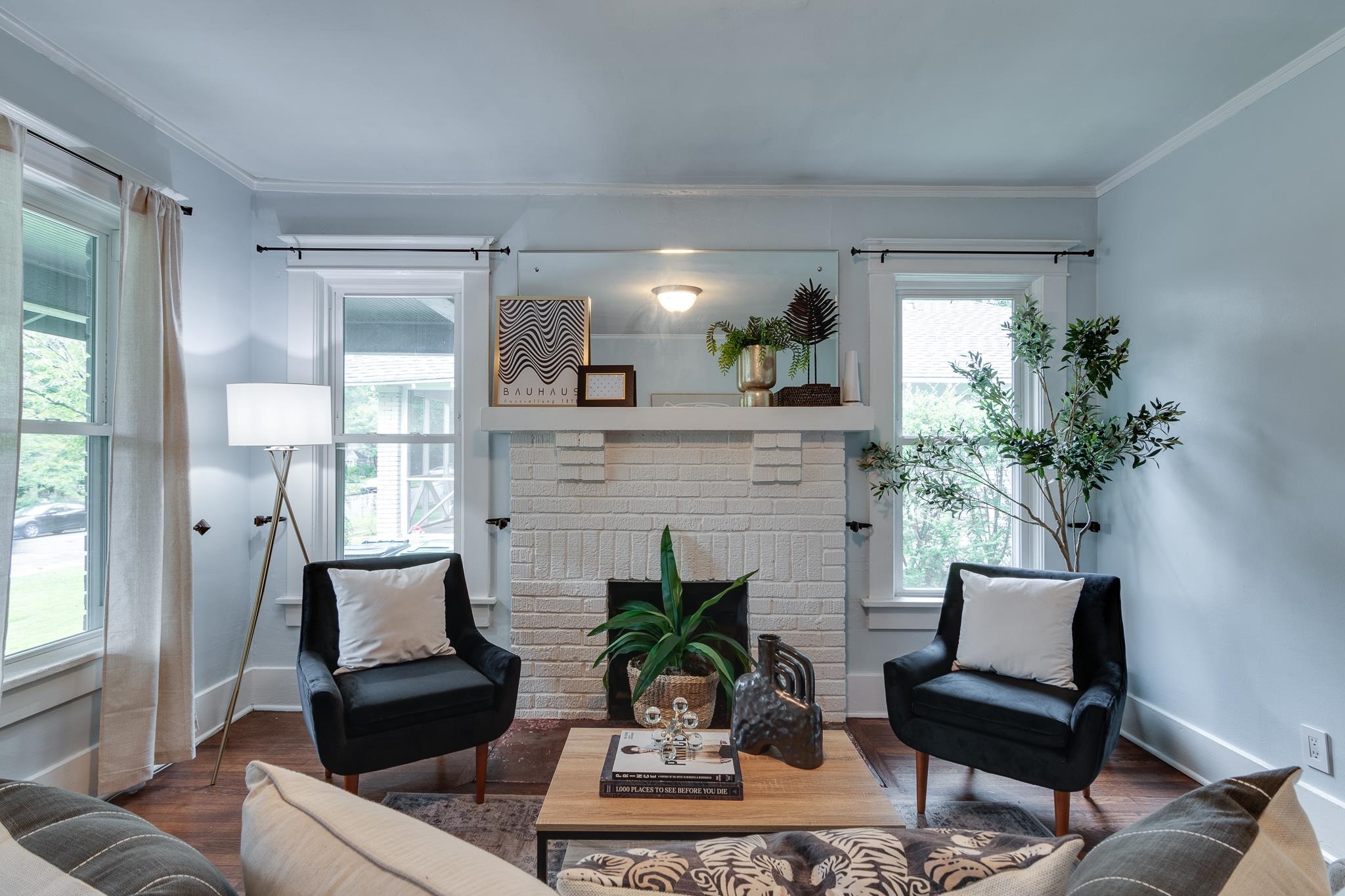 524 Alexander Street Memphis, TN 38111 - Photo 6 of 34 Living room featuring a wealth of natural light, dark wood-type flooring, a brick fireplace, and crown molding