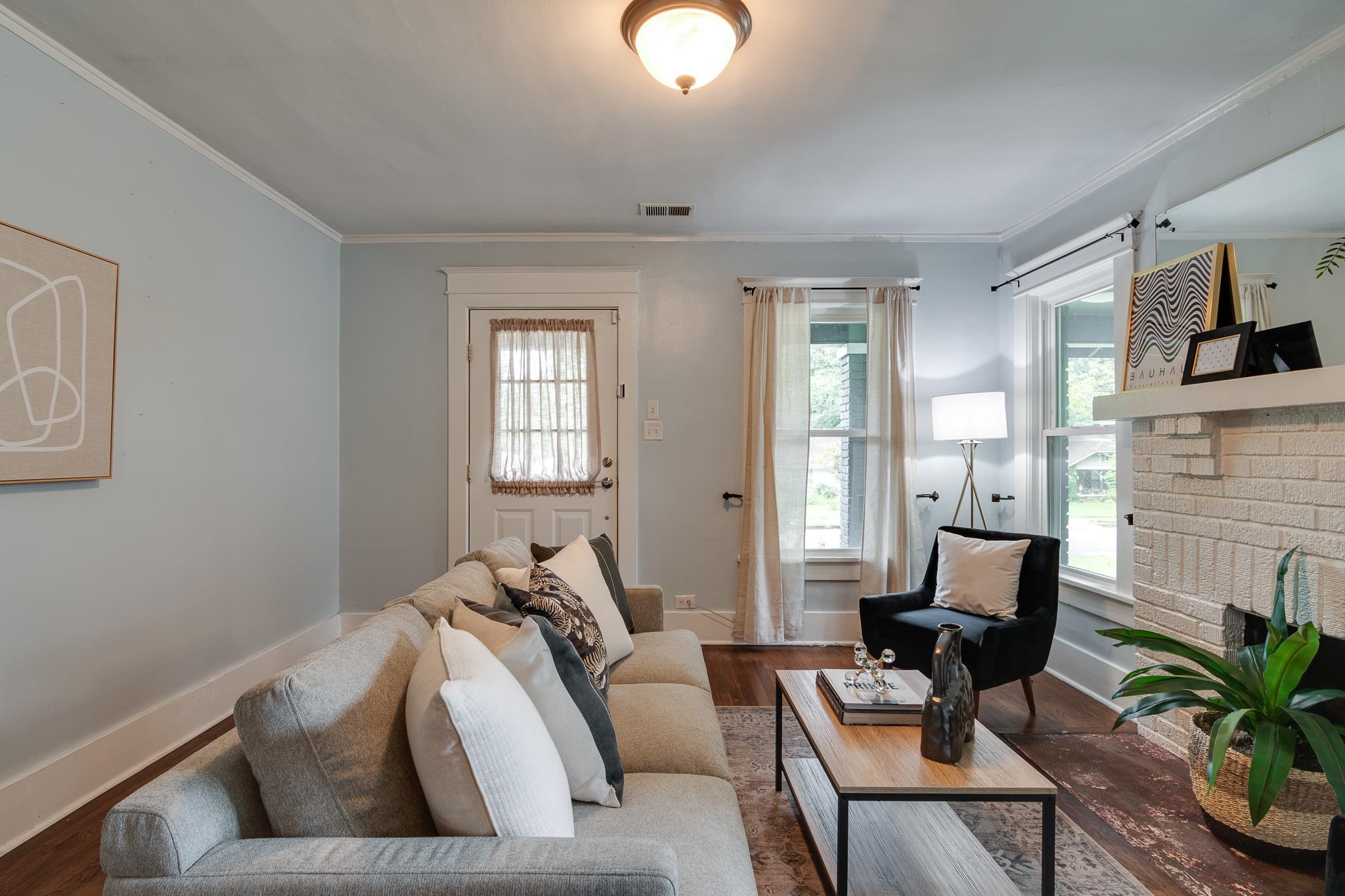 524 Alexander Street Memphis, TN 38111 - Photo 8 of 34 Living room featuring hardwood / wood-style flooring, a fireplace, and crown molding