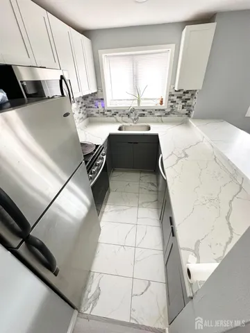 a kitchen with a sink and appliances