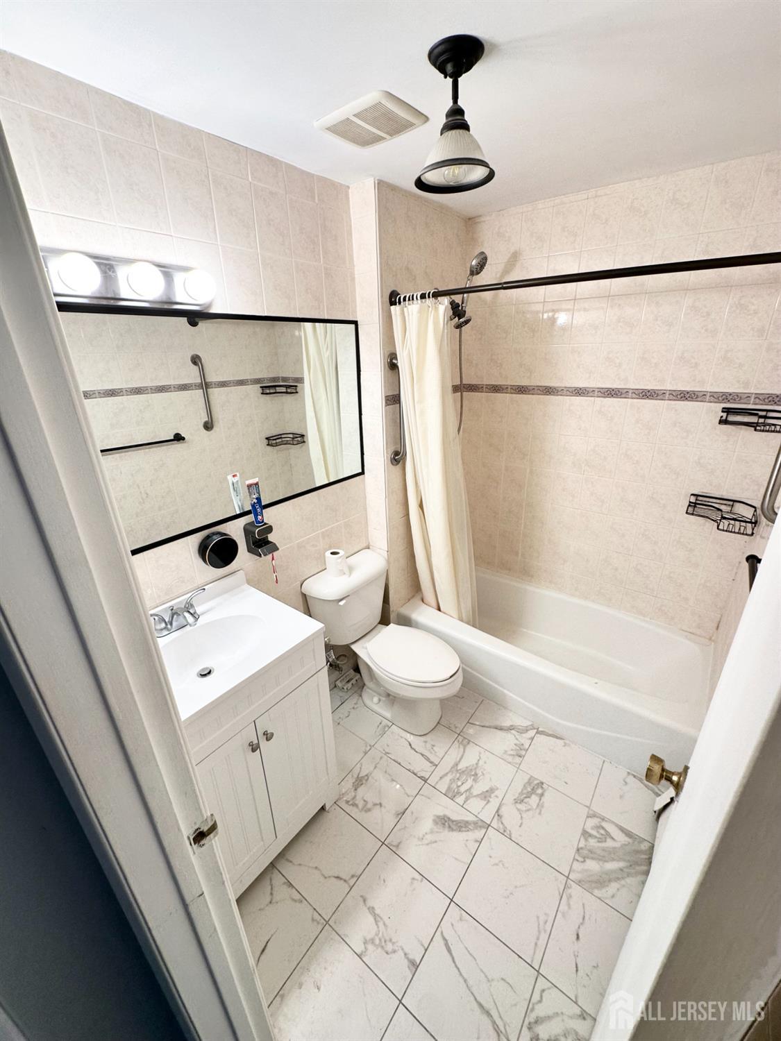 1604 74th Street, Unit B4 North Bergen, NJ 07047 - Photo 9 of 15 a bathroom with a sink a toilet and shower