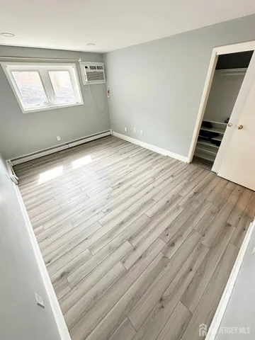 an empty room with wooden floor