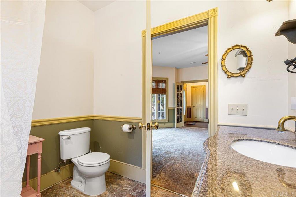 333 Salmon Road Ramona, CA 92065 - Photo 14 of 44 a bathroom with a granite countertop sink mirror vanity and toilet