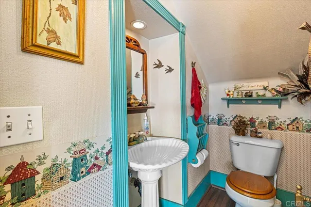 a white toilet sitting next to a bathroom sink