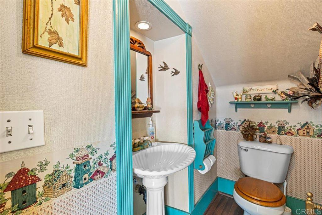 333 Salmon Road Ramona, CA 92065 - Photo 15 of 44 a white toilet sitting next to a bathroom sink