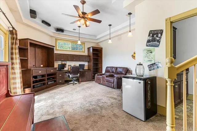 a living room with furniture a flat screen tv and large windows