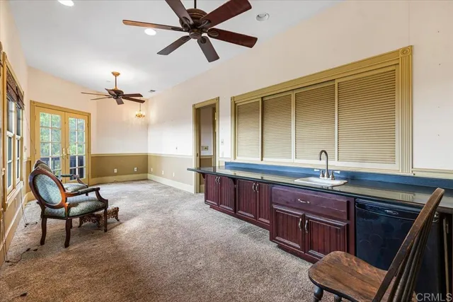 a spacious bathroom with a granite countertop sink a mirror and a bathtub